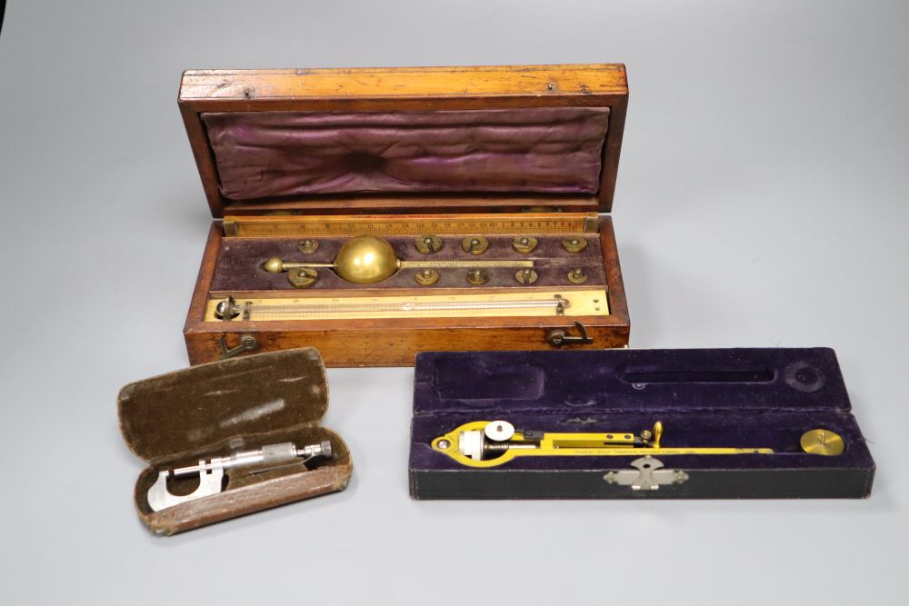 A 19th century brass Polar Planimeter (Amsler short-arm type) by Stanley, with weight and two other items,